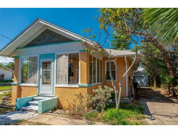 Charming home featuring a stucco exterior with ample natural light, a quaint entrance, and landscaped surroundings at 605 Goodall Ave, Daytona Beach, FL 32118