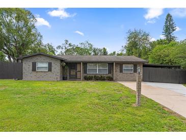 Charming single-story home with a well-manicured lawn and neutral brick facade at 795 Superior St, Deltona, FL 32725