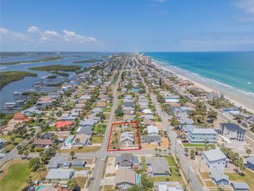 Aerial view of a beachside home near the ocean and inter-coastal waterway at 101 Egret Ave, Port Orange, FL 32127
