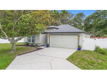 Charming single Gathering home with a two-car garage, landscaped yard, and walkway leading to the entrance at 105 Golfside Cir, Sanford, FL 32773
