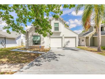 Charming two-story home with a two-car garage and a well-maintained front yard at 1229 Saddleback Ridge Rd, Apopka, FL 32703
