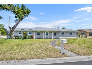 Charming single-story home with a well-maintained lawn, front yard tree, and a welcoming walkway at 150 Reef Rd, South Daytona, FL 32119