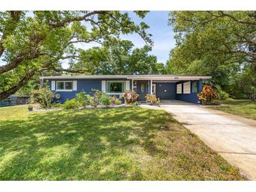 Charming home with a well-manicured lawn, lush landscaping, and a convenient carport at 220 Buena Vista St, Debary, FL 32713