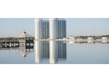Scenic view of waterfront condos, reflecting on the water, with a gazebo in the foreground at 241 Riverside Dr # 902, Holly Hill, FL 32117