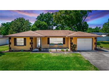 Charming single-story home featuring well-manicured lawn and neat, appealing landscaping at 242 Linda Vista St, Debary, FL 32713