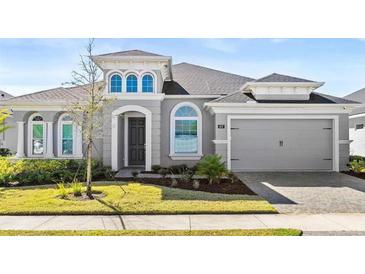 Charming single-Gathering home featuring a well-manicured lawn and a two-car garage at 617 Mosaic Blvd, Daytona Beach, FL 32124