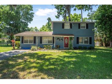 Charming two-story home featuring a well-maintained lawn and traditional architectural details at 1228 Oakwood Ave, Daytona Beach, FL 32114
