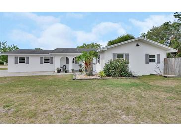 Charming single-story home with a well-maintained lawn, arched entrance, and colorful flower beds in the front yard at 1590 Urbana Ave, Deltona, FL 32725