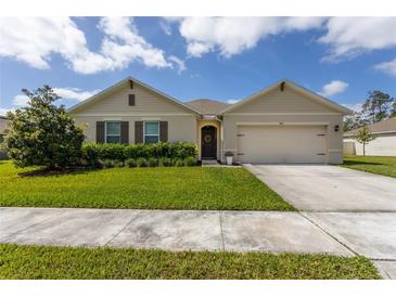 Charming single-story home with well-manicured lawn and attached two car garage at 258 Sandoval Dr, Ormond Beach, FL 32174