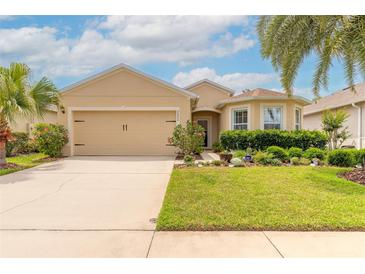 Charming single-Gathering home features a well-manicured lawn, mature landscaping, and a two-car garage at 2672 Star Coral Ln, New Smyrna Beach, FL 32168