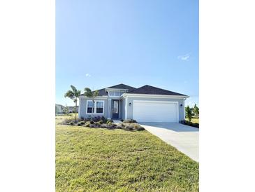 Charming single-story home with manicured lawn, two-car garage and welcoming entrance at 4133 Gilford Cir, Ormond Beach, FL 32174