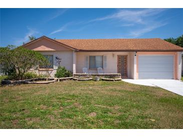 Charming single-story home with a well-maintained lawn and lovely front garden at 5519 Silent Brook Dr, Orlando, FL 32821