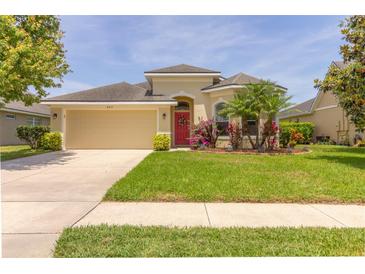 Charming one story home with a well-manicured lawn and colorful landscaping at 6917 Vintage Ln, Port Orange, FL 32128