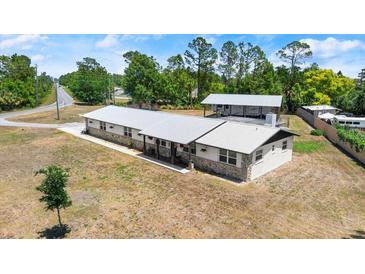 Charming single story home featuring a metal roof and decorative stone accents at 793 Timothy St, Ormond Beach, FL 32174