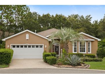 Beautiful single-story home with a manicured lawn, complemented by a two-car garage and a welcoming front entrance at 8231 Sw 79Th Ct, Ocala, FL 34476