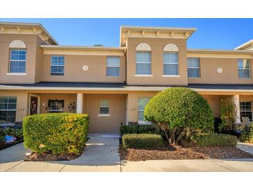 Inviting two-story townhouse with manicured landscaping and covered porch entryway at 109 Bel Fiore Cv, Sanford, FL 32773