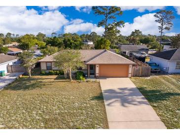 Charming single-story home boasts a large front yard, long driveway, and attached two-car garage at 3107 Mapleshade St, Deltona, FL 32738