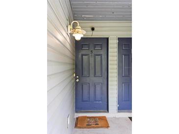 Close up of front door #5 and welcome mat for this home at 313 Dirksen Dr # A5, Debary, FL 32713