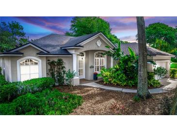 Charming single-story home with beautiful landscaping and a welcoming front entrance at 397 Quail Hill Dr, Debary, FL 32713
