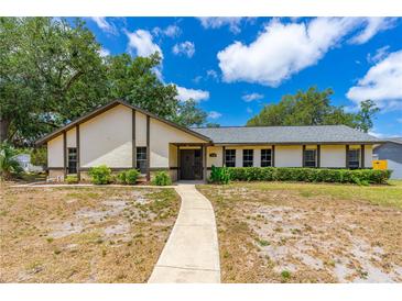 Charming single-story home with manicured landscaping and a welcoming walkway leading to the entrance at 5788 Devon St, Port Orange, FL 32127