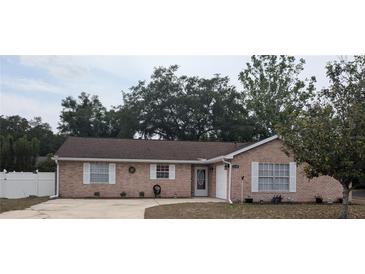 Charming single-story brick home featuring a well-maintained front yard and attached garage at 1250 Lemonwood Ave, Deland, FL 32724