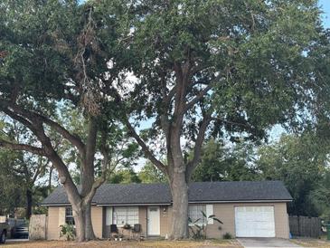 Charming single-story home with mature trees and a cozy front porch at 2219 Howland Blvd, Deltona, FL 32738