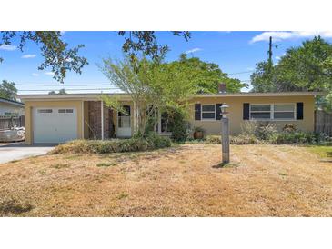 Charming single-story home featuring an attached garage and well-kept front yard at 2327 Mulbry Dr, Winter Park, FL 32789