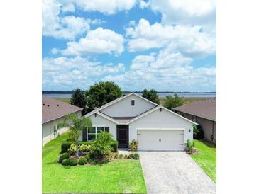 Beautiful one-story home featuring a well-maintained lawn, complemented by decorative landscaping and a neutral color scheme at 343 Lazio Cir, Debary, FL 32713