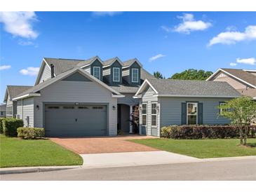 Charming home with a well-manicured lawn and a two-car garage on a sunny day at 5430 Nw 35Th Lane Rd, Ocala, FL 34482