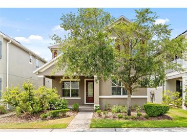 Charming two-story home featuring a landscaped front yard and a welcoming entrance at 8832 Ribault Ave, Orlando, FL 32832