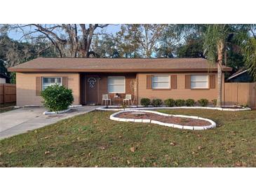 Inviting single-story home featuring well-maintained landscaping and a cozy front porch area at 921 Valleydale Ave, Deland, FL 32720