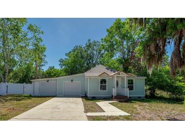Charming single-story home with light blue exterior, well-manicured lawn, and a long driveway at 940 Valencia Ave, Daytona Beach, FL 32114