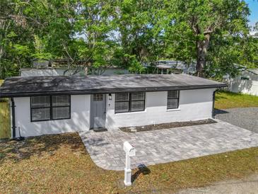 Charming single-story home featuring a fresh white exterior, new gray brick walkway, and mailbox at 102 Judges Ln, Port Orange, FL 32129