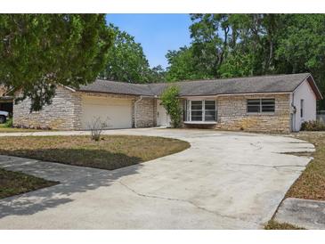 Charming single-story home featuring a stone facade and a two-car garage at 1209 James Ter, Daytona Beach, FL 32117