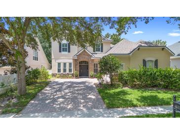 Charming two-story home featuring a stone entryway and a well-manicured front lawn at 123 Ivydale Manor Dr, Deland, FL 32724