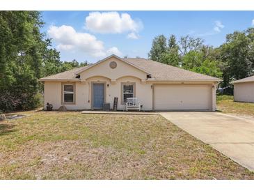 Charming single-story home featuring a well-maintained lawn and attached two-car garage at 149 Angeles Rd, Debary, FL 32713