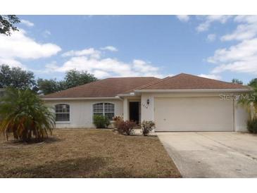 Charming single-story home with a well-maintained lawn and a spacious two-car garage at 1714 Urbana Ave, Deltona, FL 32725