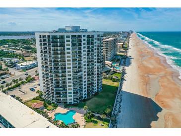 Stunning aerial view of a beachfront condo building with a pool and expansive beach access at 2425 S Atlantic Ave # 1202A, Daytona Beach Shores, FL 32118