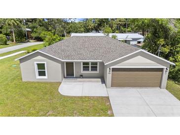 Charming one-story home featuring a two-car garage, well-manicured lawn, and a welcoming front entrance at 560 Sumner Ave, Orange City, FL 32763
