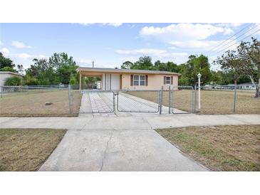 Charming single-story home with a fenced yard and covered carport at 566 S Floyd Cir, Deltona, FL 32725