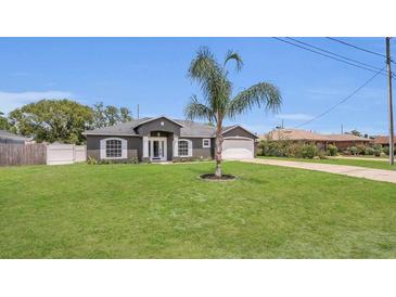 Well-maintained single-story home with landscaped front yard and attached two-car garage at 1194 Balfour Dr, Deltona, FL 32725