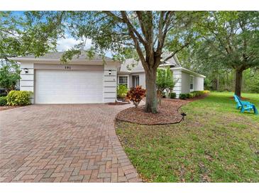 Well-maintained single Gathering home featuring lush landscaping and a brick driveway at 191 Sedona Cir, Daytona Beach, FL 32124