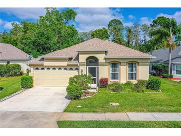Charming single-story home with a well-manicured lawn, mature landscaping, and a two-car garage at 200 Gala Cir, Daytona Beach, FL 32124