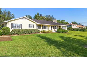 Charming single-story home with lush green lawn and mature landscaping at 701 N Tuxedo Ave, Deland, FL 32724
