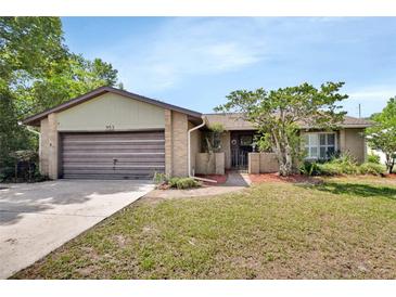 Charming single-story brick home featuring a well-maintained lawn and attached garage, creating a cozy curb appeal at 953 Tulip St, Deltona, FL 32725