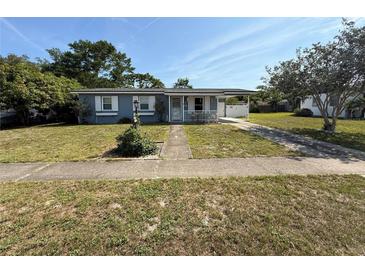Charming single-story home featuring a cozy front porch and a convenient covered carport at 1081 Cobblestone Ave, Deltona, FL 32725
