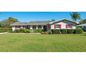 Charming single-story home with well-maintained lawn, red shutters, and mature landscaping at 1155 E Fowler Dr, Deltona, FL 32725