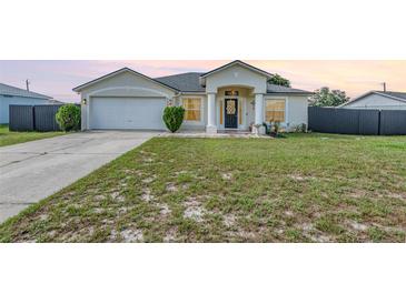 Charming single-Gathering home featuring a well-manicured lawn, inviting entry, and attached two-car garage at 2884 Sweet Springs St, Deltona, FL 32738