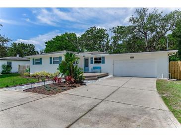 Charming single-story home with blue shutters and a well-manicured front yard at 556 N Beach St, Ormond Beach, FL 32174