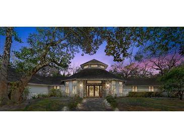 Inviting front facade with stone accents and manicured landscaping creates a warm and welcoming entrance at 5721 John Anderson Hwy, Flagler Beach, FL 32136